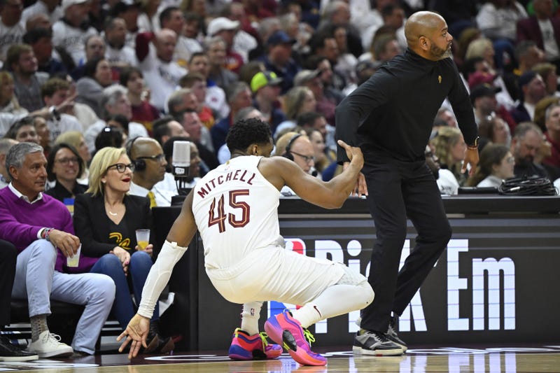 Cleveland Cavaliers head coach J. B. Bickerstaff helps guard Donovan Mitchell (45) to his feet in the second quarter against the Orlando Magic during game two of the first round of the 2024 NBA playoffs at Rocket Mortgage FieldHouse.
