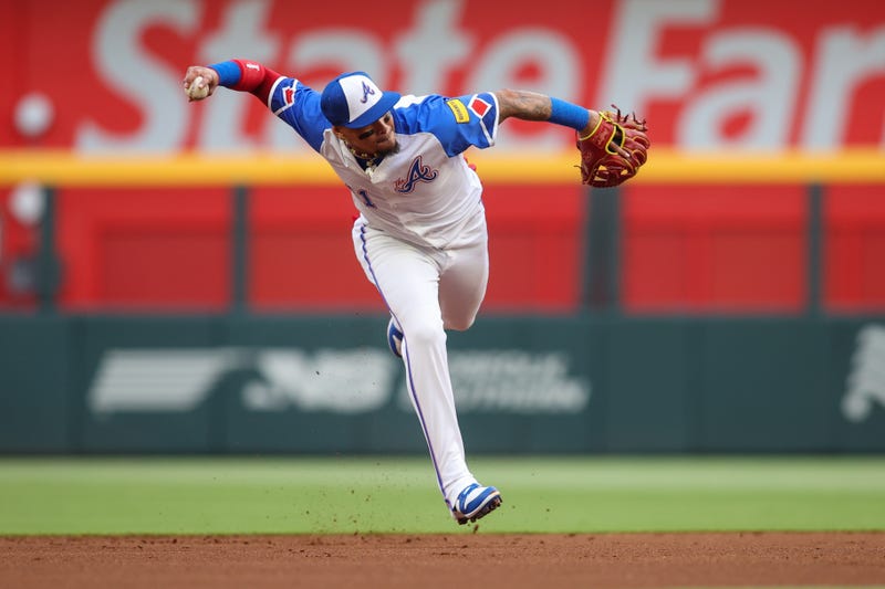Atlanta Braves shortstop Orlando Arcia (11) attempts to throw a runner out at first against the Cleveland Guardians in the first inning at Truist Park. 