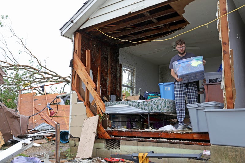 Sean Thomas Sledd salvages items from his room after it was hit by a tornado the night before in Sulphur, Okla., Sunday, April 28, 2024.