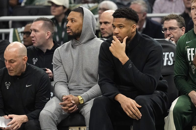 Damian Lillard and forward Giannis Antetokounmpo watch from the bench during the first quarter during game five of the first round for the 2024 NBA playoffs against the Indiana Pacers