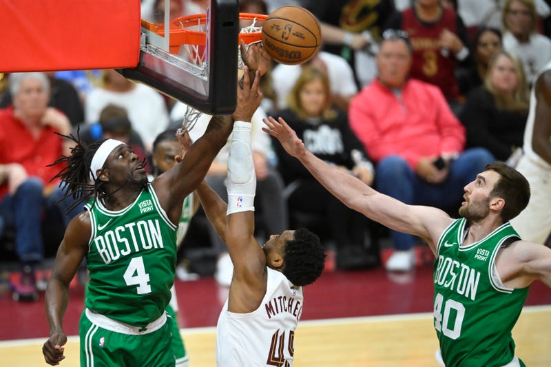 May 11, 2024; Cleveland, Ohio, USA; Cleveland Cavaliers guard Donovan Mitchell (45) shoots the ball against Boston Celtics guard Jrue Holiday (4) and center Luke Kornet (40) in the third quarter of game three of the second round of the 2024 NBA playoffs at Rocket Mortgage FieldHouse.