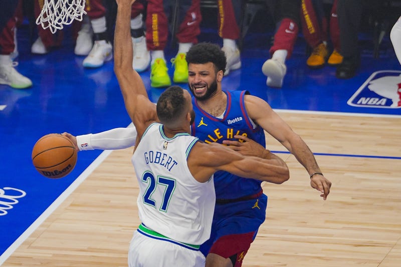 Nuggets guard Jamal Murray (27) passes against the Minnesota Timberwolves center Rudy Gobert (27) in the first quarter during game six of the second round for the 2024 NBA playoffs at Target Center.