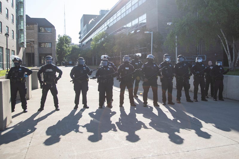 Wayne State police with riot shields line up next to Atchison Hall