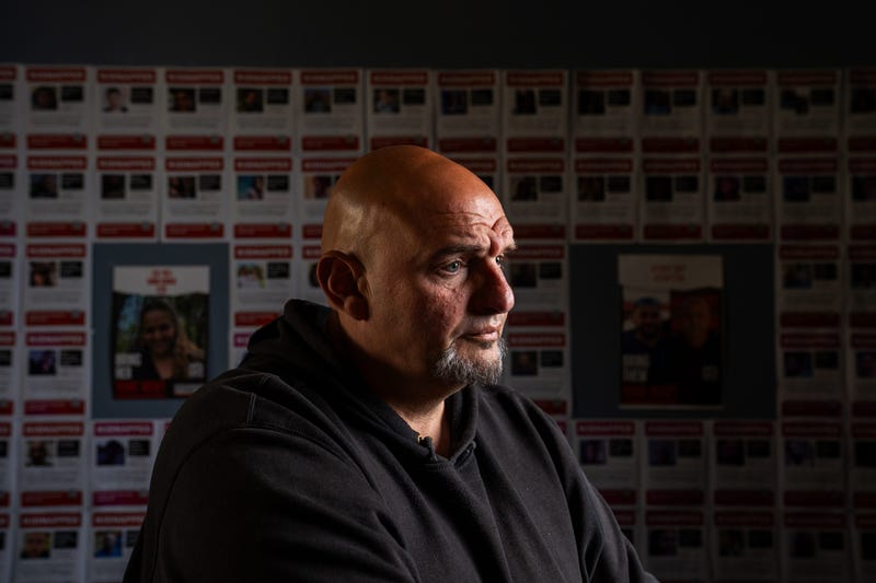 Sen. John Fetterman, D-Pa., poses for a portrait in front of posters of Israeli hostages in his front office at the U.S. Capitol