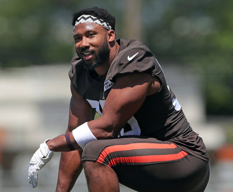 Cleveland Browns defensive end Myles Garrett relaxes on the sideline during NFL minicamp at CrossCountry Mortgage Campus, Wednesday, June 12, 2024, in Berea, Ohio.