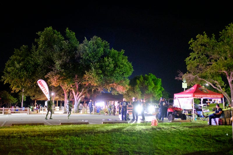 Round Rock police officers coordinate efforts near their mobile emergency command center in the aftermath of a shooting at Old Settlers Park in Round Rock late on Saturday night and into early Sunday, June 16, 2024.