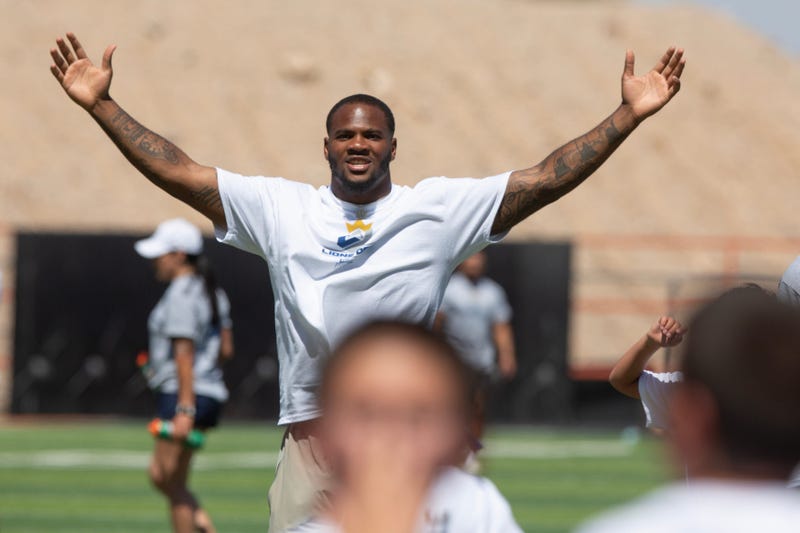 Dallas Cowboys star Micah Parsons enjoys playing with kids at El Paso High School during a football camp for youth on June 17, 2024.