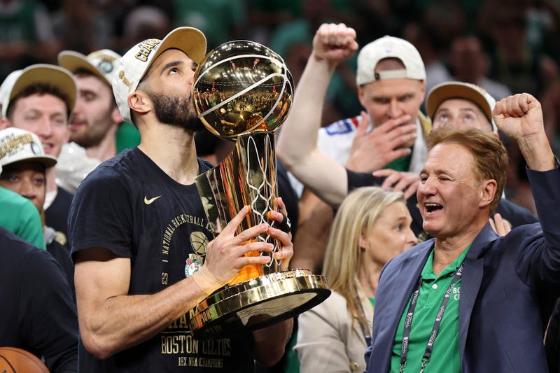 Boston Celtics forward Jayson Tatum (0) kisses the trophy after winning the 2024 NBA Finals against the Dallas Mavericks at TD Garden.