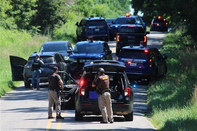 Law enforcement officers are seen actively searching for a suspect who  gunned down a Hillsdale County Sheriff's deputy Thursday during a traffic stop.