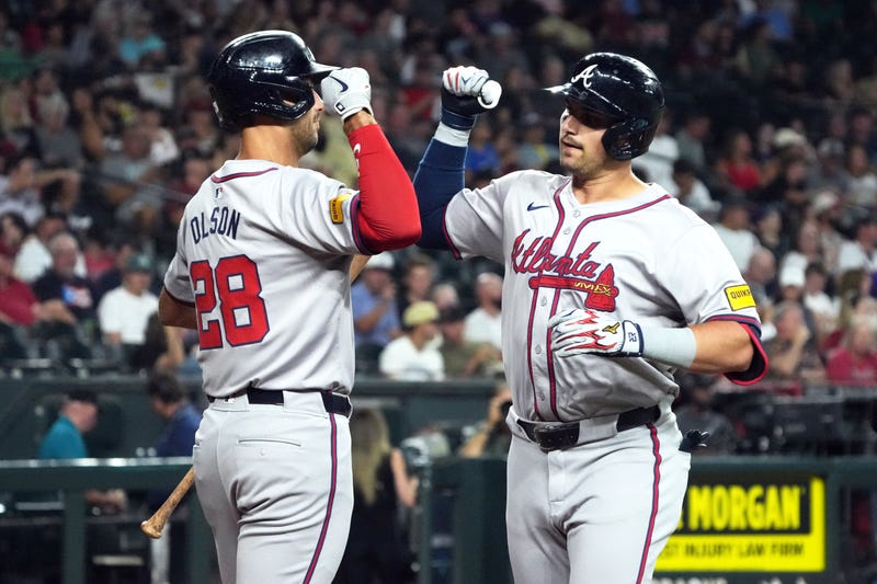 Atlanta Braves third base Austin Riley (27) celebrates with first baseman Matt Olson (28) after hitting a solo home run against the Arizona Diamondbacks in the first inning at Chase Field.