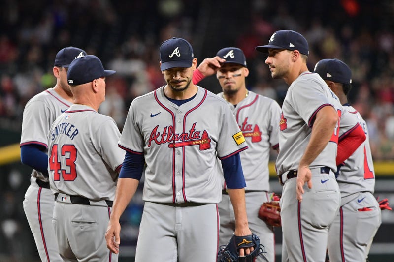 Atlanta Braves pitcher Charlie Morton (50) is pulled from the game by manager Brian Snitker (43) in the seventh inning against the Arizona Diamondbacks at Chase Field.
