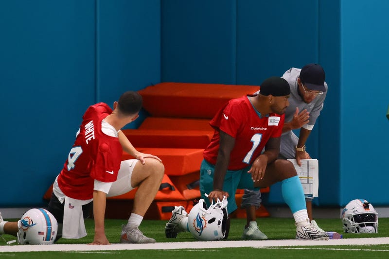 Miami Dolphins head coach Mike McDaniel talks to quarterback Tua Tagovailoa (1) during training camp at Baptist Health Training Complex.
