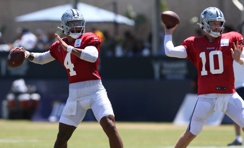 Dallas Cowboys quarterback Dak Prescott (4) throws next to quarterback Cooper Rush (10) during training camp.