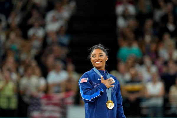 Simone Biles of the United States during the national anthem with her gold medal during the medal ceremony for the vault