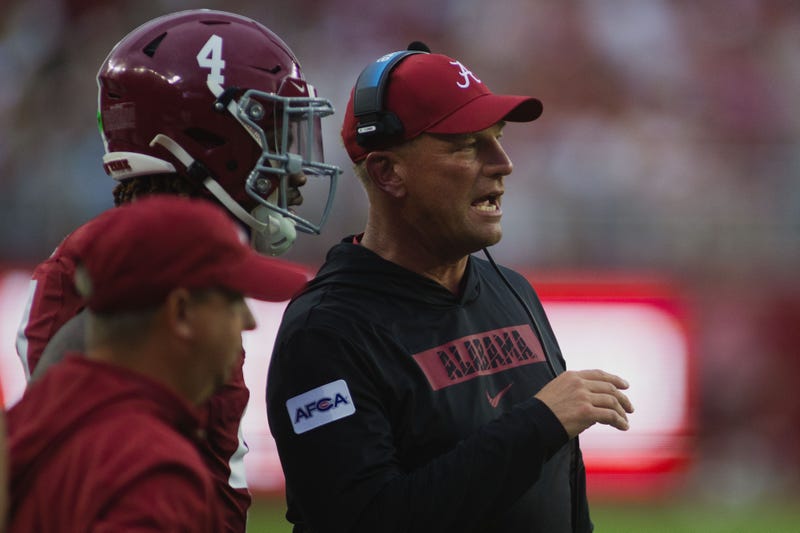 Alabama Crimson Tide head coach Kalen DeBoer talks to Alabama Crimson Tide quarterback Jalen Milroe