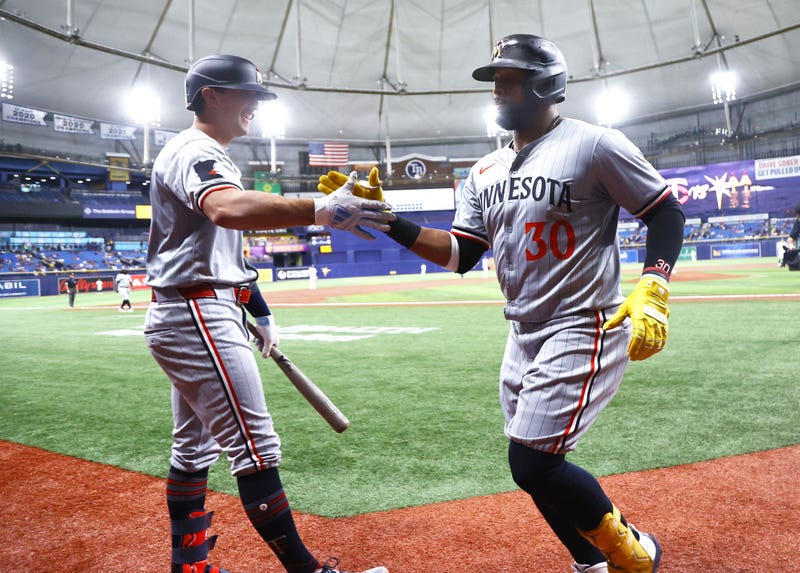 Twins first base Carlos Santana (30) is congratulated by infielder Brooks Lee (72) after hitting a home run against the Tampa Bay Rays during the second inning at Tropicana Field.