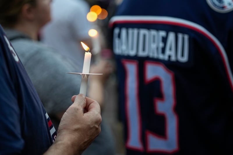 Mourners gather for a candlelight vigil to remember Columbus Blue Jackets forward Johnny Gaudreau at Nationwide Arena