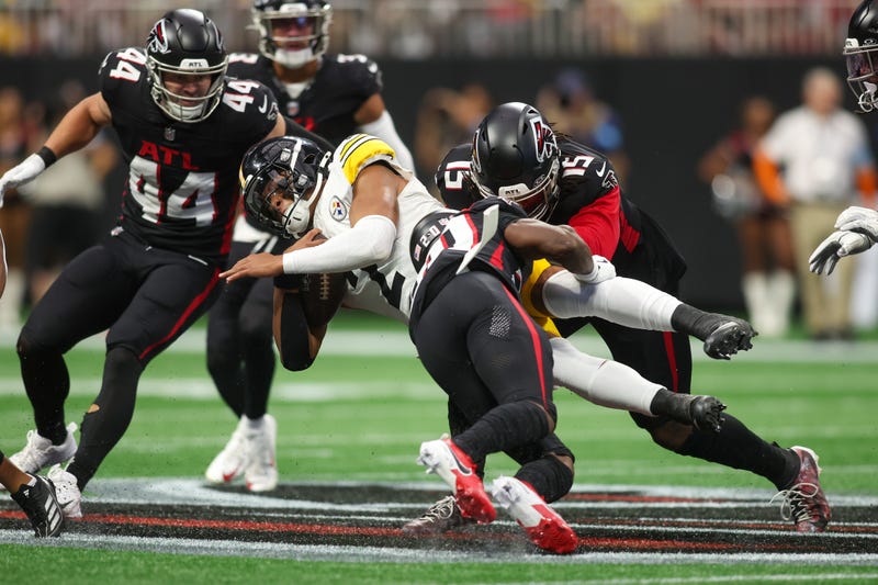 Sep 8, 2024; Atlanta, Georgia, USA; Pittsburgh Steelers quarterback Justin Fields (2) is tackled by Atlanta Falcons cornerback Dee Alford (20) and linebacker Matthew Judon (15) in the second quarter at Mercedes-Benz Stadium. Mandatory Credit: Brett Davis-Imagn Images