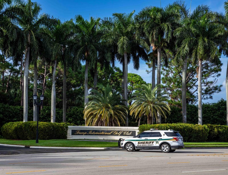 A Palm Beach County sheriff's vehicle is parked adjacent to the Trump International Golf Club sign in West Palm Beach, Florida. The FBI on Sunday is investigating an attempted assassination of former President Donald Trump