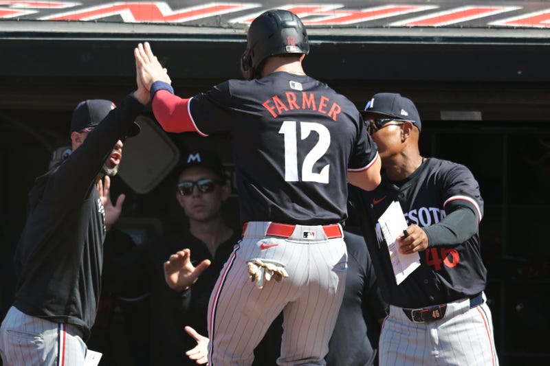 Minnesota Twins second baseman Kyle Farmer (12) celebrates after scoring during the fifth inning against the Cleveland Guardians at Progressive Field.