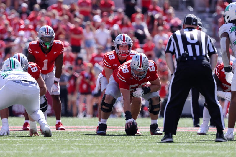 Ohio State Buckeyes quarterback Will Howard (18) lines up under Ohio State Buckeyes offensive lineman Seth McLaughlin (56) during the third quarter against the Marshall Thundering Herd at Ohio Stadium.