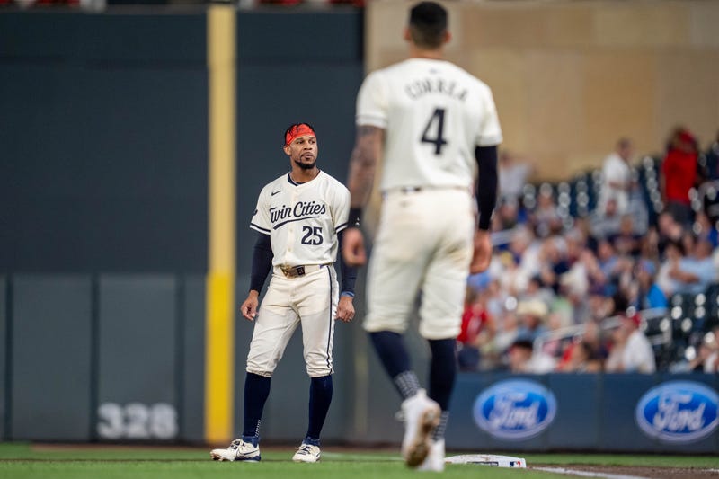 Twins outfielder Byron Buxton (25) is stranded on base after Minnesota Twins shortstop Carlos Correa (4) strikes out to end the seventh inning against the Miami Marlins at Target Field.
