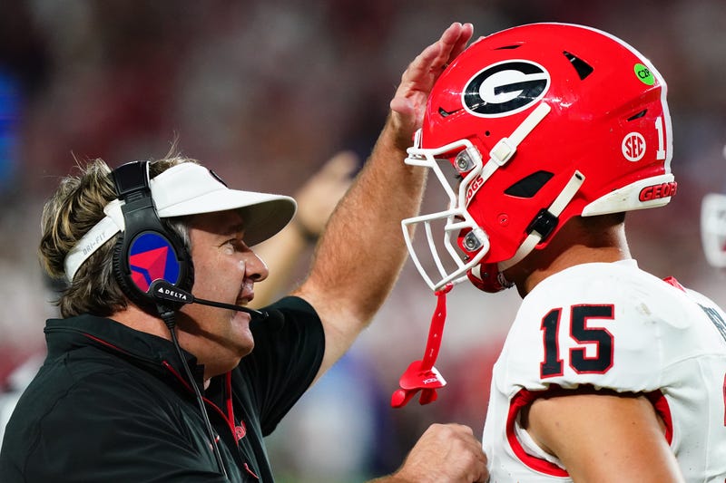 Georgia Bulldogs head coach Kirby Smart talks with quarterback Carson Beck