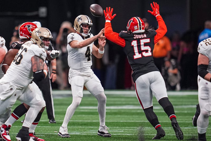 Sep 29, 2024; Atlanta, Georgia, USA; Atlanta Falcons linebacker Matthew Judon (15) deflects a pass by Atlanta Falcons quarterback Kirk Cousins (18) that is intercepted and returned for a touchdown during the first half at Mercedes-Benz Stadium. Mandatory Credit: Dale Zanine-Imagn Images