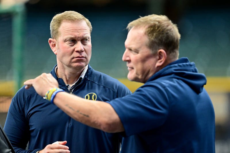 Oct 2, 2024; Milwaukee, Wisconsin, USA; Milwaukee Brewers general manager Matt Arnold talks to manager Matt Arnold before game two of the Wildcard round for the 2024 MLB Playoffs against the New York Mets at American Family Field. Mandatory Credit: Benny Sieu-Imagn Images