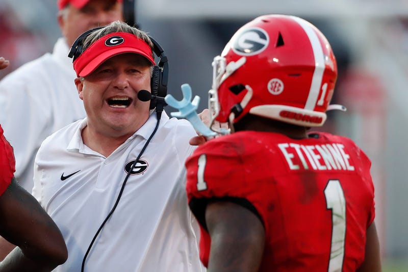 Georgia head coach Kirby Smart celebrates with Georgia running back Trevor Etienne (1) during the second half of a NCAA college football game against Auburn in Athens, Ga