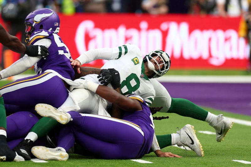 New York Jets quarterback Aaron Rodgers (8) suffers an injury after a tackle from Minnesota Vikings Linebacker Patrick Jones II (91) in the 3rd Quarter at Tottenham Hotspur Stadium. 