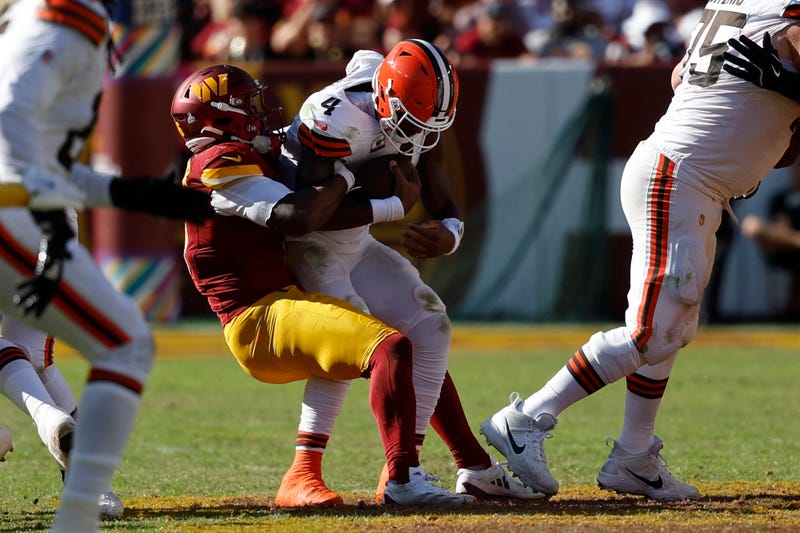 Cleveland Browns quarterback Deshaun Watson (4) is sacked by Washington Commanders linebacker Dante Fowler Jr. (6) during the third quarter at NorthWest Stadium.