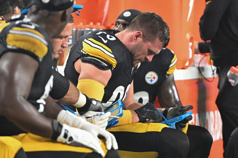TJ Watt on bench looking at tablet