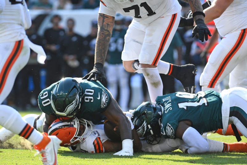 Philadelphia Eagles defensive tackle Jordan Davis (90) and linebacker Josh Sweat (19) tackle Cleveland Browns quarterback Deshaun Watson (4) during the fourth quarter at Lincoln Financial Field