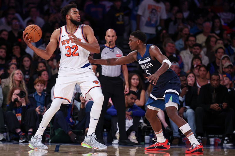 That's definitely going to take getting used to. New York Knicks center Karl-Anthony Towns (32) looks to pass as Minnesota Timberwolves guard Anthony Edwards (5) at Madison Square Garden. 