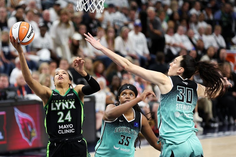 Lynx forward Napheesa Collier (24) shoots as New York Liberty forward Jonquel Jones (35) and forward Breanna Stewart (30) defend during the second half of game four of the 2024 WNBA Finals at Target Center. 