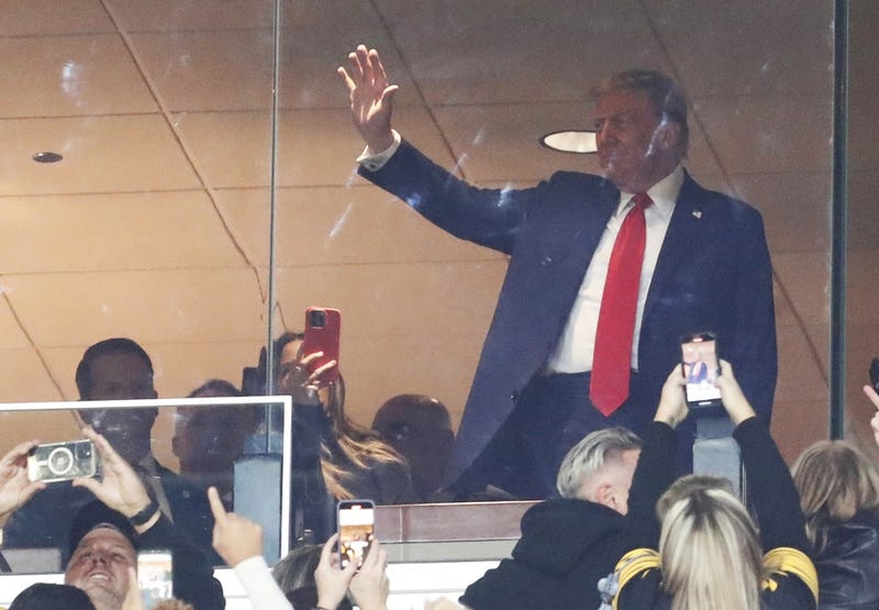 Former President Donald Trump waves to the crowd as the Pittsburgh Steelers play the New York Jets during the first quarter at Acrisure Stadium. 
