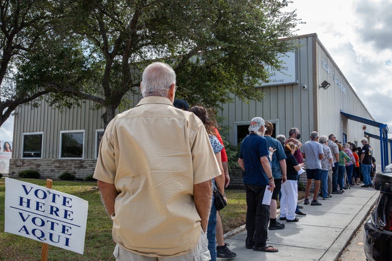 A line of voters stretches along the sidewalk outside of the Deaf and Hard of Hearing Center on the first day of early voting, Monday, Oct. 21, 2024, in Corpus Christi, Texas.