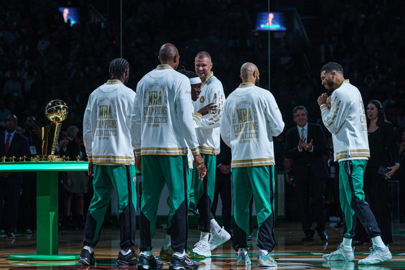 Boston, Massachusetts, USA; Boston Celtics forward Jayson Tatum (0) is presented with a championship ring during the opening night banner raising ceremony before the start of the game against the New York Knicks at TD Garden.