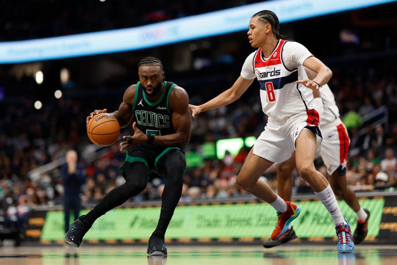 Jaylen Brown (7) drives to the basket as Washington Wizards forward Kyshawn George (18) defends