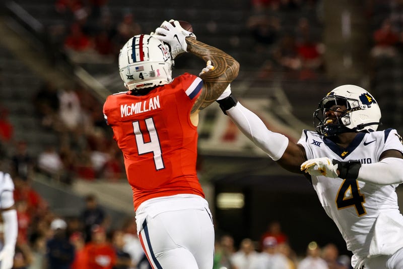 Oct 26, 2024; Tucson, Arizona, USA; Arizona Wildcats wide receiver Tetairoa McMillan (4) catches a long pass while West Virginia Mountaineers linebacker Trey Lathan (4) fails to defend against him during the fourth quarter at Arizona Stadium. Mandatory Credit: Aryanna Frank-Imagn Images