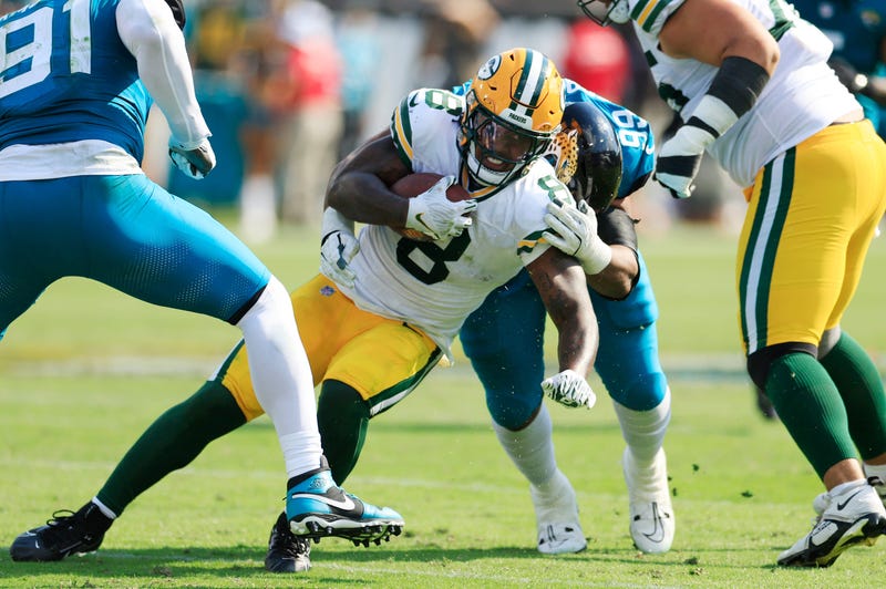 Green Bay Packers running back Josh Jacobs (8) is tackled by Jacksonville Jaguars defensive tackle Jeremiah Ledbetter (99) during the third quarter of an NFL football matchup Sunday, Oct. 27, 2024 at EverBank Stadium in Jacksonville, Fla. The Packers edged the Jaguars 30-27 on a last-second field goal.