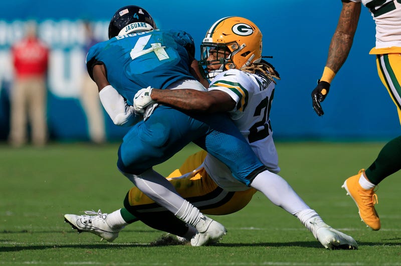 Green Bay Packers safety Xavier McKinney (29) tackles Jacksonville Jaguars running back Tank Bigsby (4) during the fourth quarter of an NFL football matchup Sunday, Oct. 27, 2024 at EverBank Stadium in Jacksonville, Fla. The Packers edged the Jaguars 30-27 on a last-second field goal