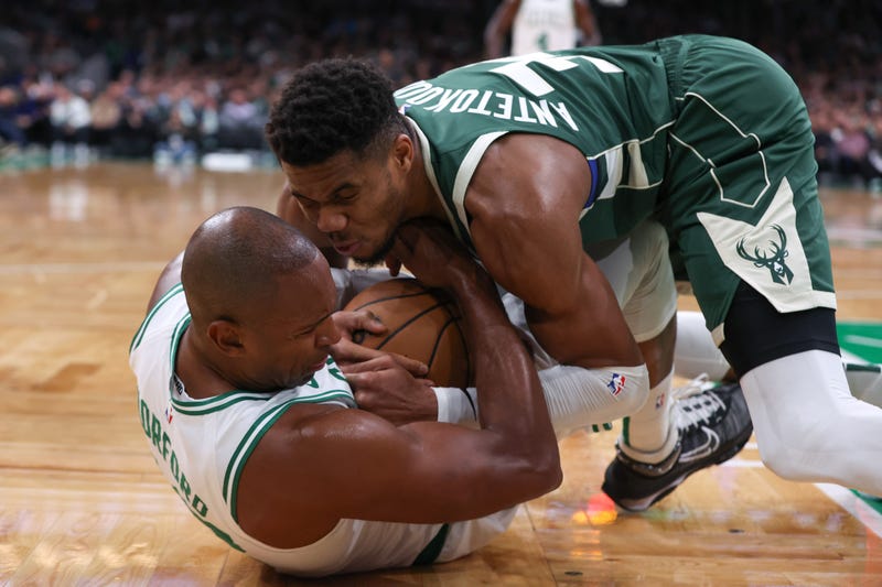 Boston, Massachusetts, USA; Milwaukee Bucks forward Giannis Antetokounmpo (34) and Boston Celtics center Al Horford (42) fight for the ball during the second half at TD Garden.