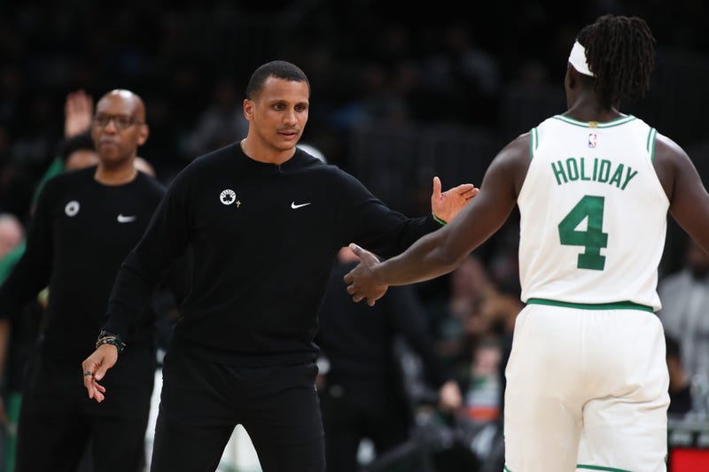 Boston Celtics head coach Joe Mazzulla celebrates with Boston Celtics guard Jrue Holiday (4) during the second half against the Milwaukee Bucks at TD Garden.