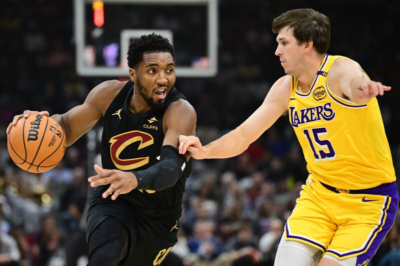 Cleveland Cavaliers guard Donovan Mitchell (45) drives to the basket against Los Angeles Lakers guard Austin Reaves (15) during the first quarter at Rocket Mortgage FieldHouse.