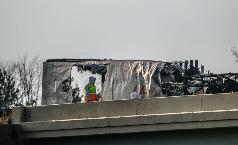 Workers are at the scene of an Interstate 96 crash near the M-52 overpass clearing wreckage near Webberville on Sunday, Nov. 3.