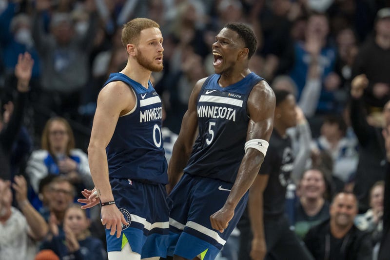Timberwolves guard Donte DiVincenzo (0) and Minnesota Timberwolves guard Anthony Edwards (5) celebrate after a shot is made against the Charlotte Hornets in the second half at Target Center.
