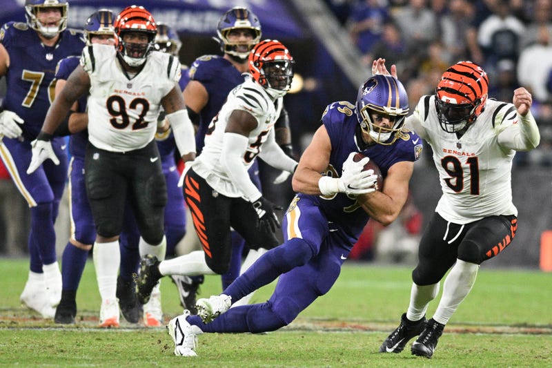 Nov 7, 2024; Baltimore, Maryland, USA; Baltimore Ravens tight end Mark Andrews (89) dices under Cincinnati Bengals defensive end Trey Hendrickson (91) after making a catch during the second half at M&T Bank Stadium. Mandatory Credit: Tommy Gilligan-Imagn Images