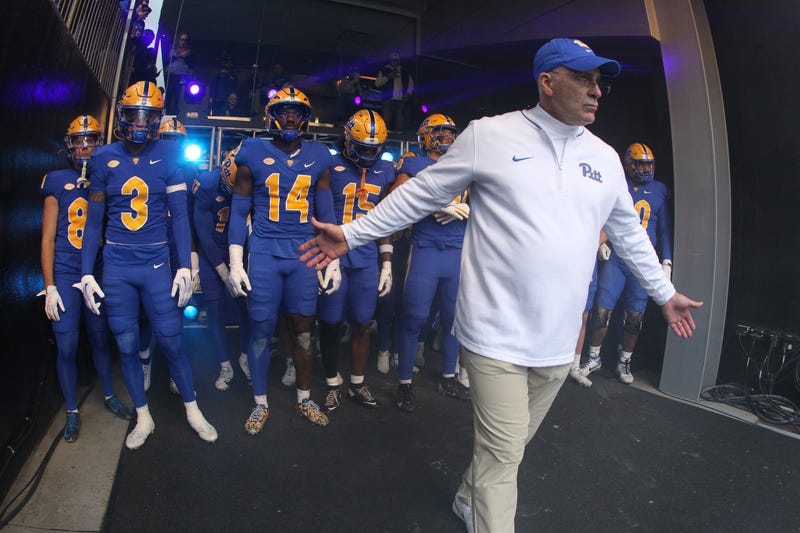 Pat Narduzzi running out on the field